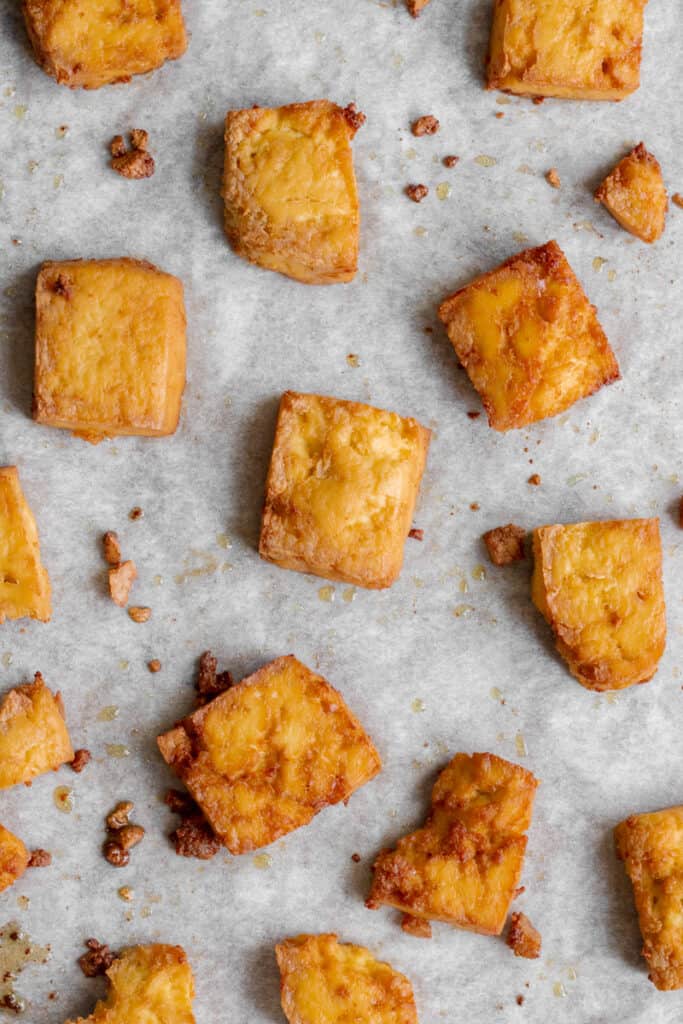 Crispy baked tofu on baking tray.