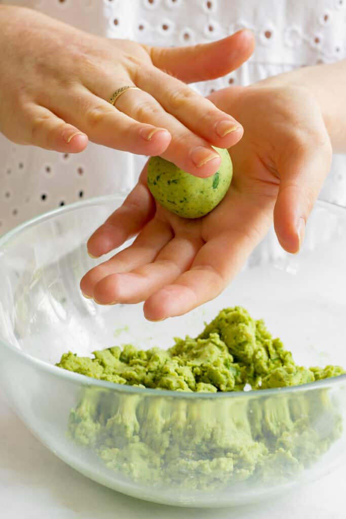 Rolling the falafel mixture into balls.