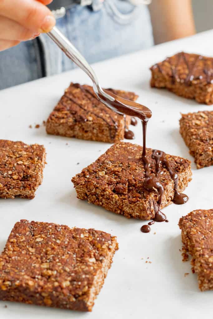 Drizzling melted chocolate over the chocolate flapjacks.