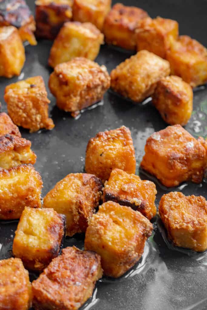 Crispy tofu in a frying pan.