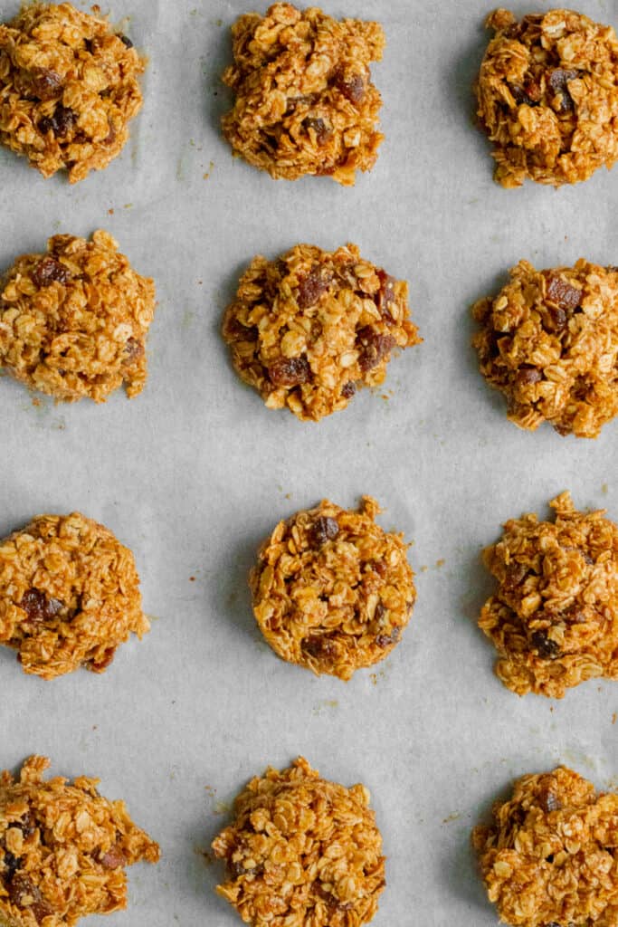 Balls of cookie mixture on a baking sheet.
