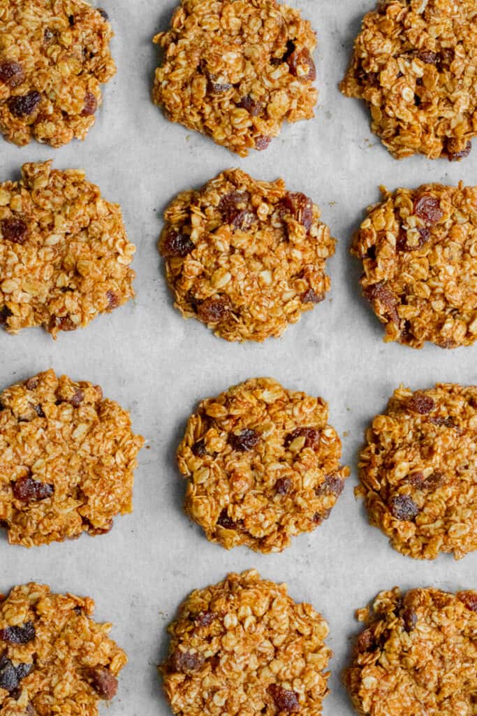 Flattened balls of cookie mixture on a baking sheet.