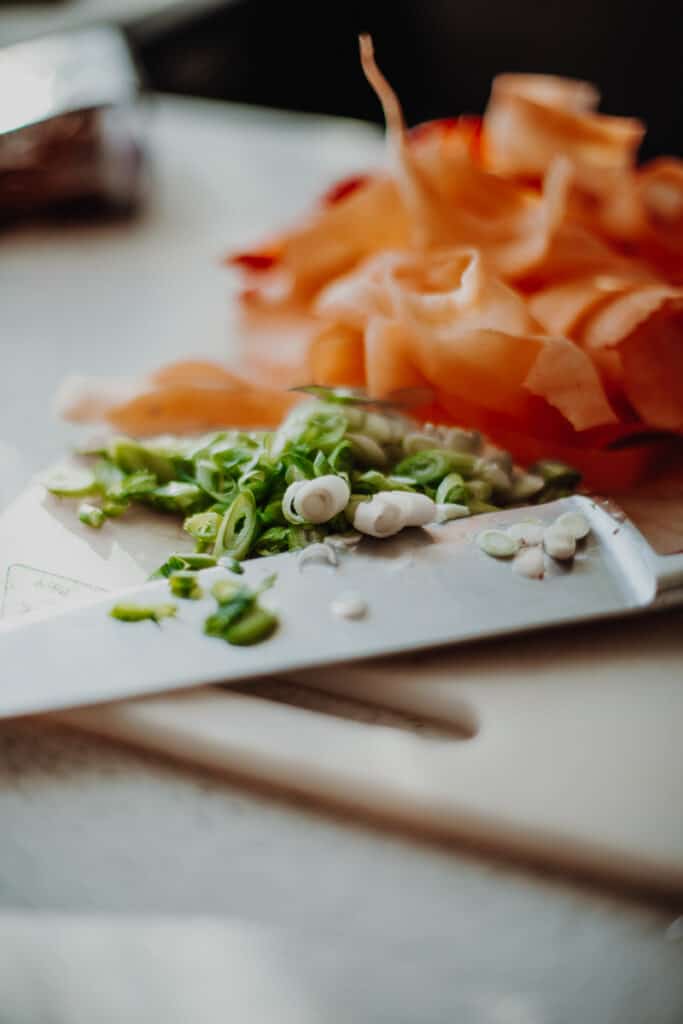 A chopping board of chopped vegetables.