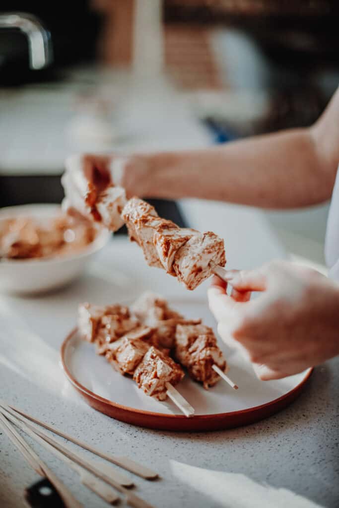 Putting the tofu chunks onto skewers.
