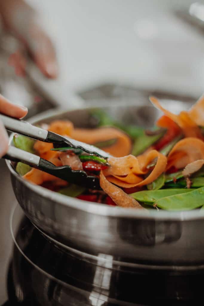 Frying the vegetables in a pan.