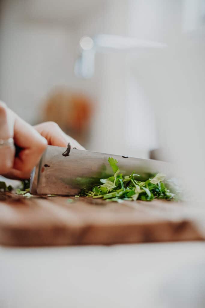 Roughly chopping the parsley.