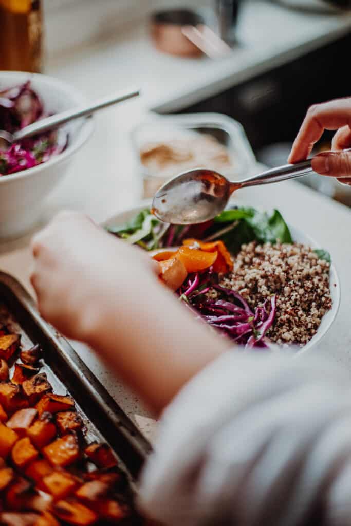 Arranging the Sweet Potato Nourish Bowl in a bowl.