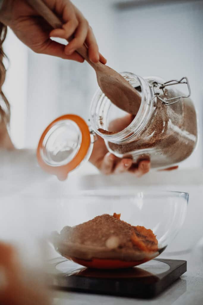 Measuring the sugar into a bowl.