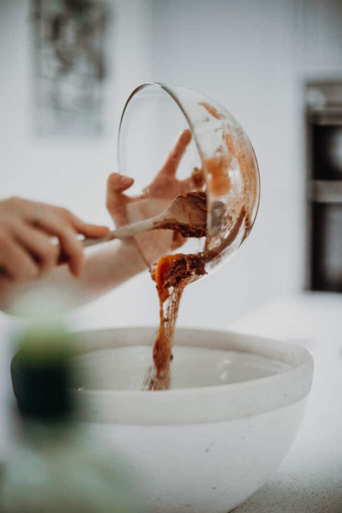 Pouring the wet ingredients into the dry ingredients.