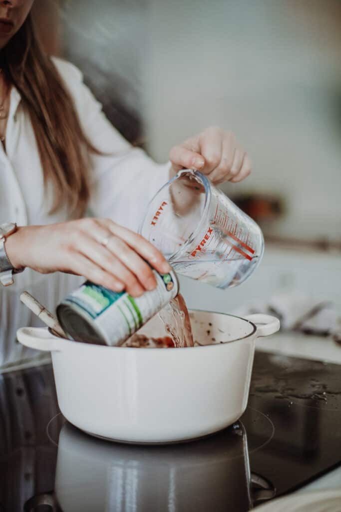 adding water into a cast-iron pot