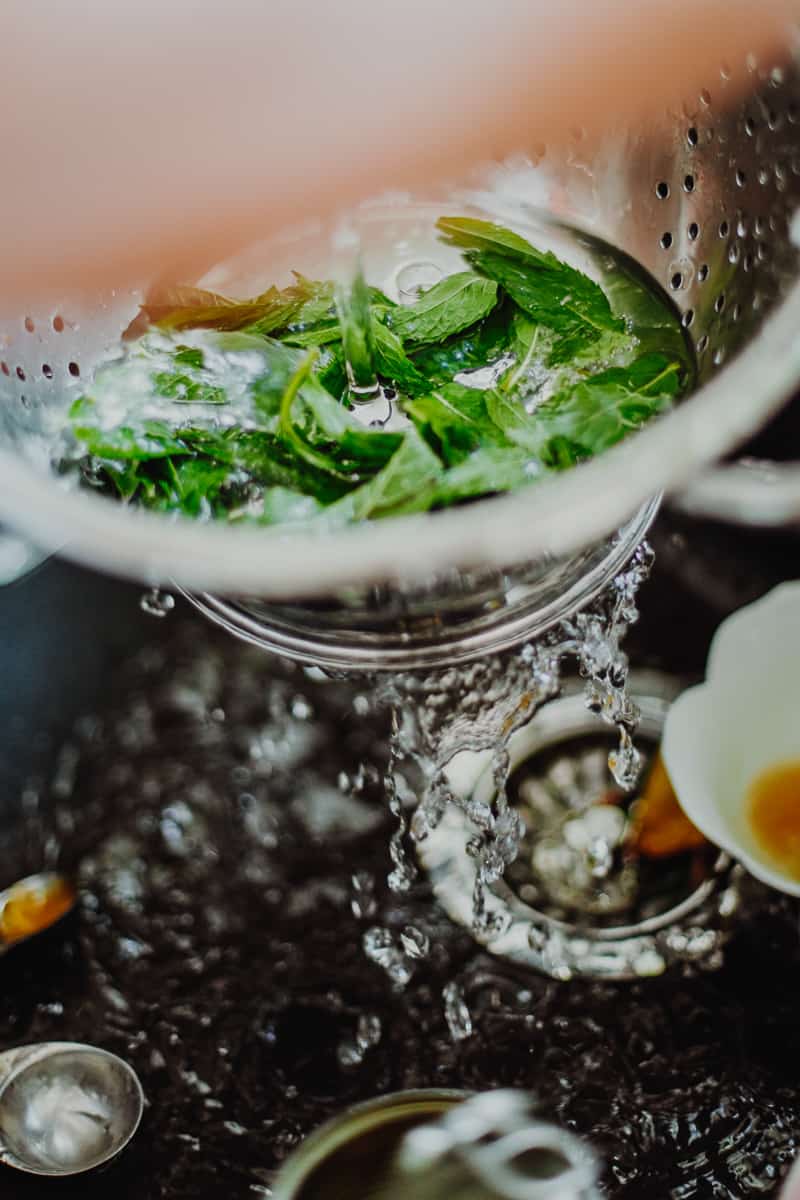 Washing the mint leaves in the sink