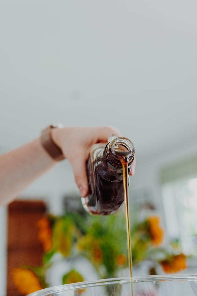 pouring maple syrup into a food processor