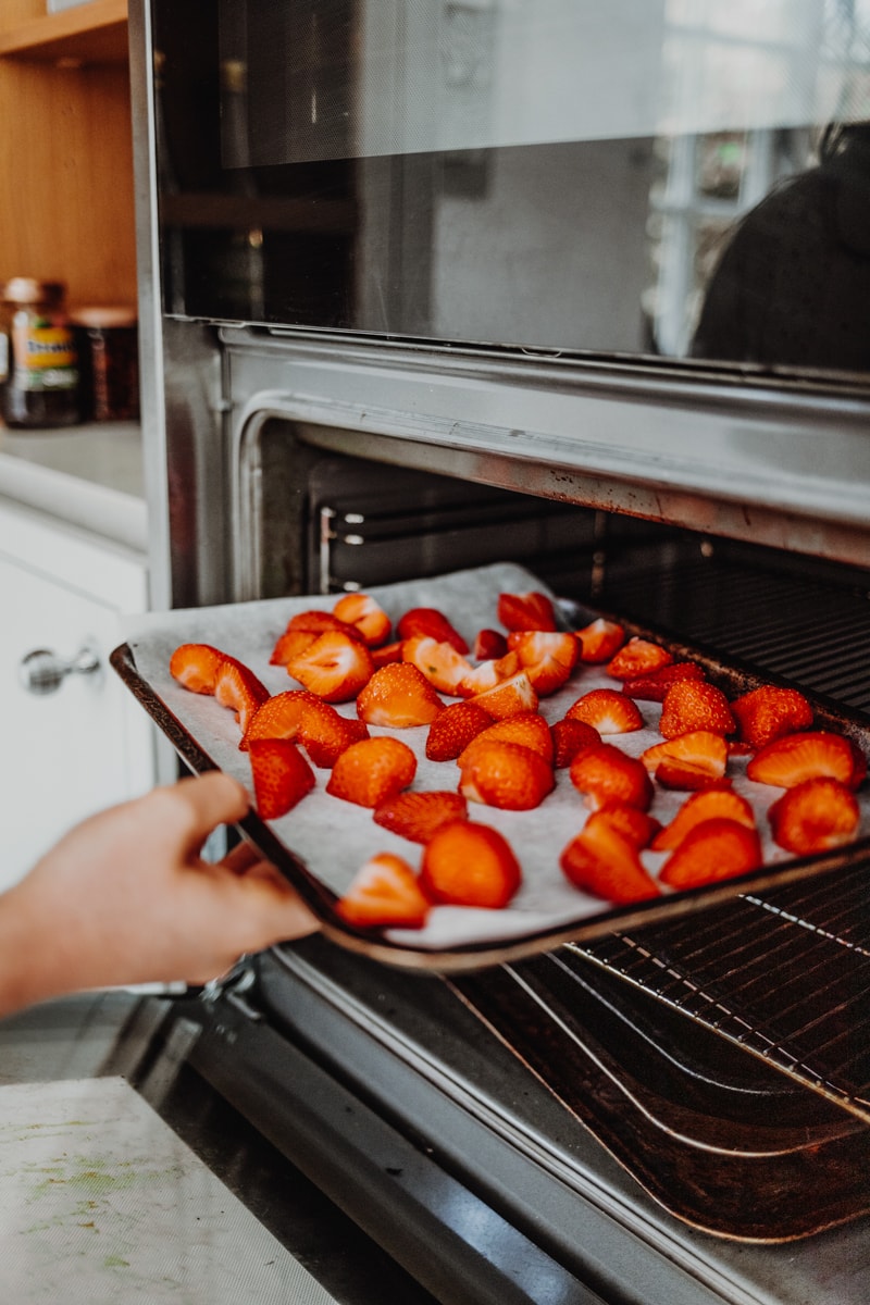 putting the strawberries in the oven to roast