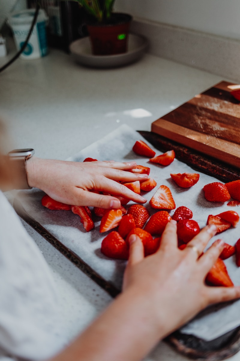 laying the strawberries out onto a baking tray