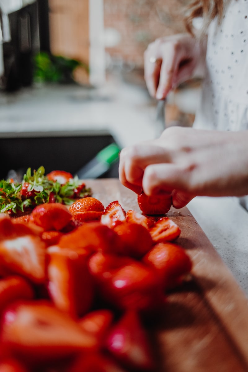 chopping strawberries in half