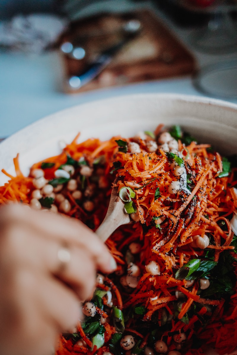 Combining all the ingredients for carrot & chickpea salad.