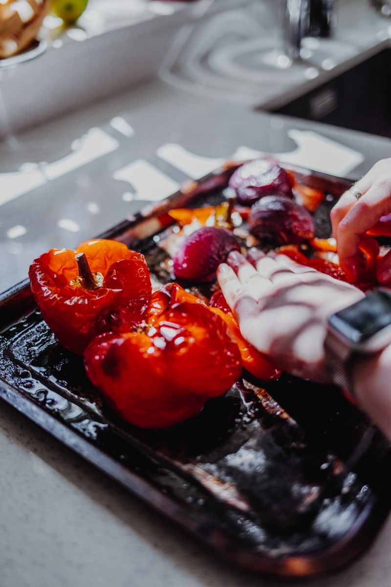 Removing the skin from the roasted red peppers