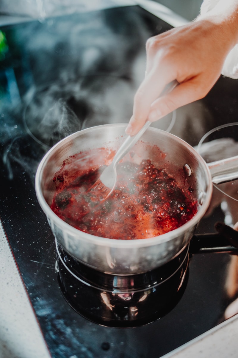 making the blackberry chia jam in a saucepan over the stove