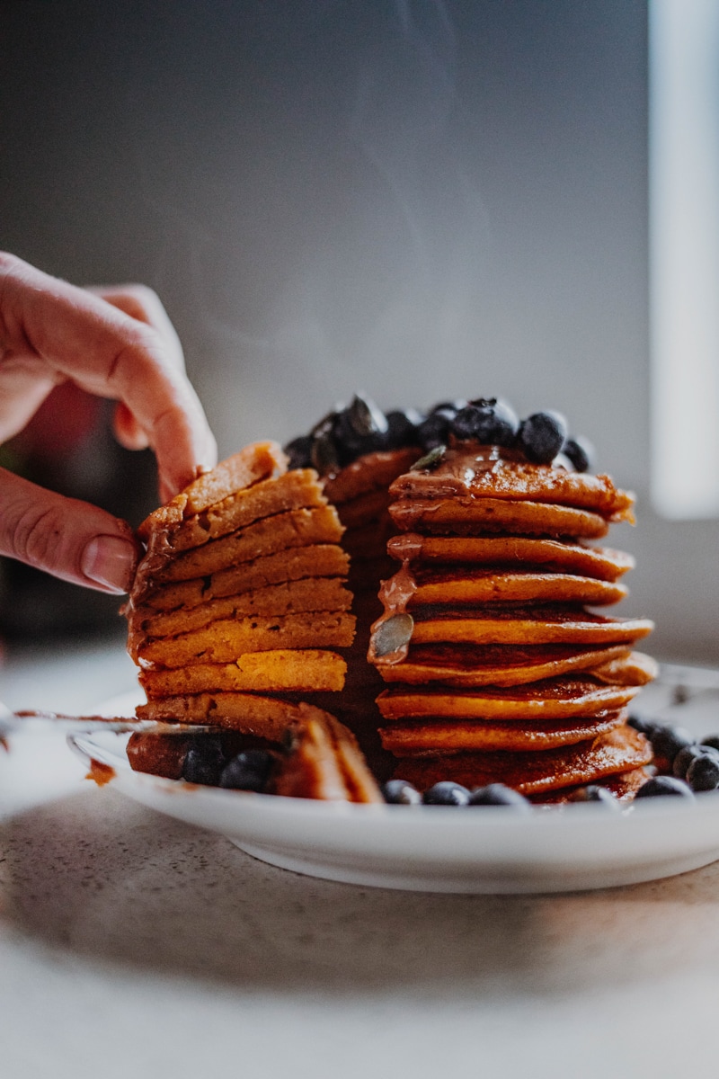 A slice of Vegan Pumpkin Pancakes - Georgie Eats.