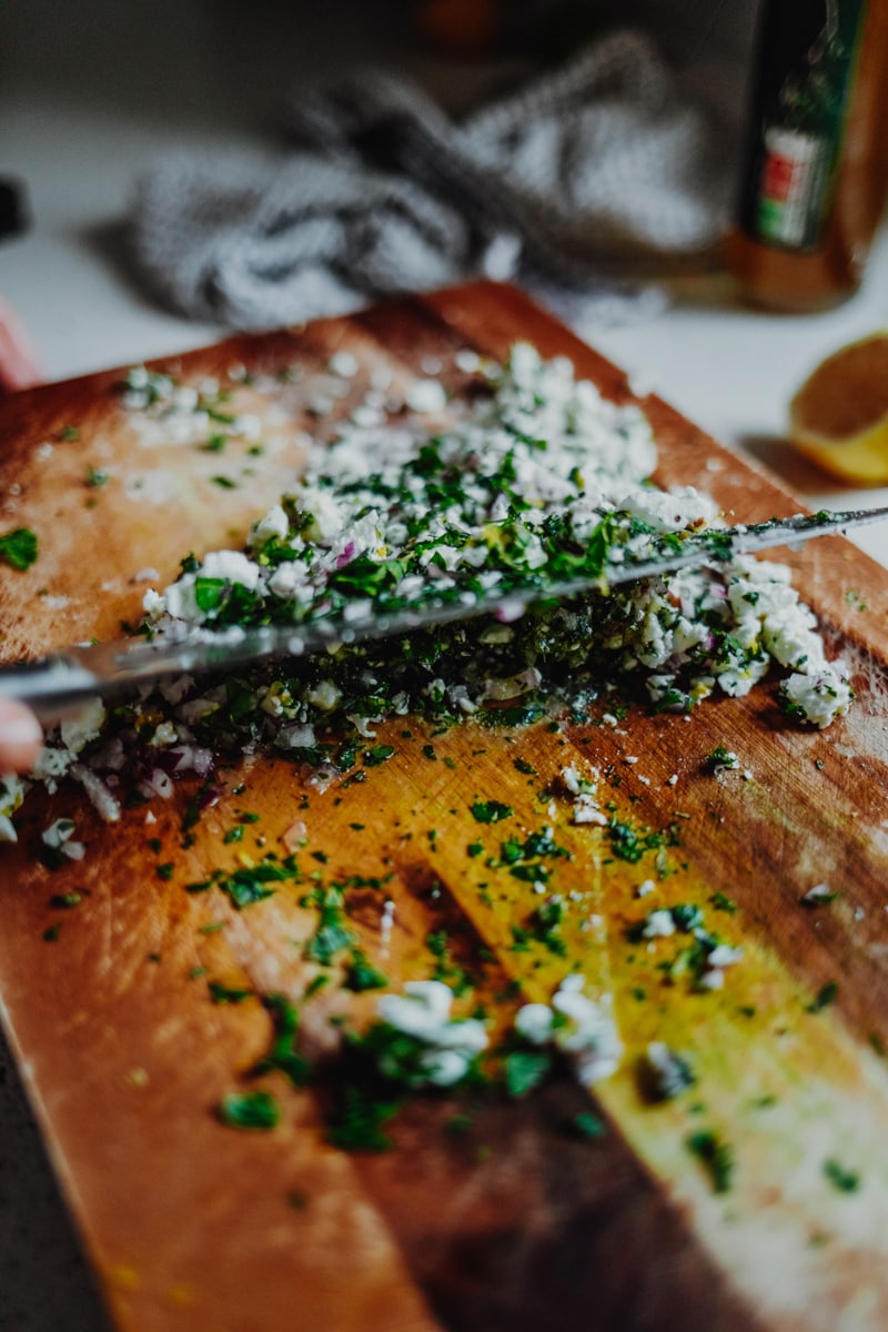 making the feta salsa on a chopping board