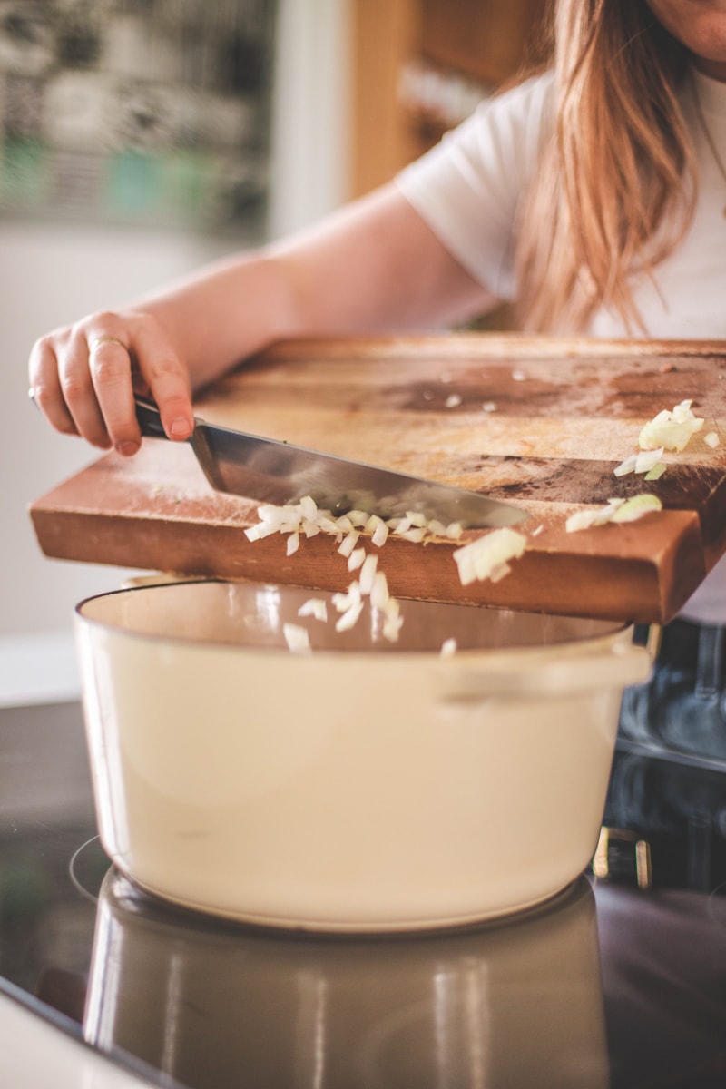 transferring chopped cauliflower into saucepan