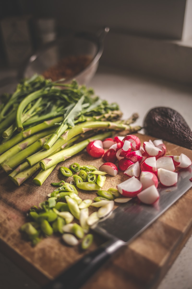 Tenderstem broccoli, radish and spring onion on a chopping board