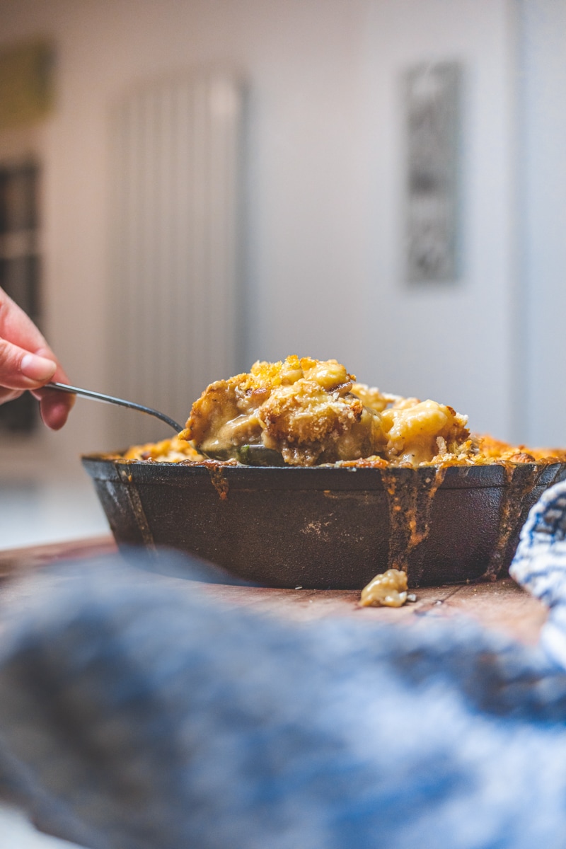 Cauliflower Cheese & Gnocchi Bake Coming being spooned from dish - Georgie Eats