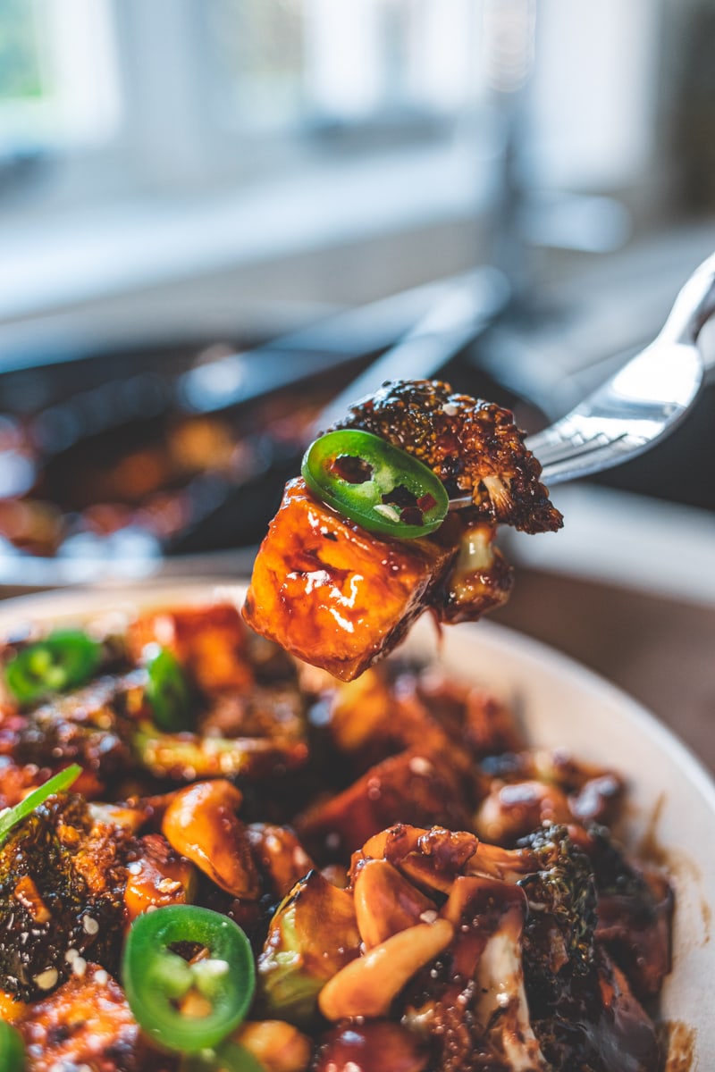 a forkful of Sticky Cashew. Broccoli & Tofu Stir-Fry - Georgie Eats