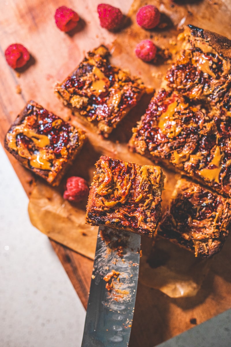 Peanut Butter & Jam Bondies on a board - Georgie Eats