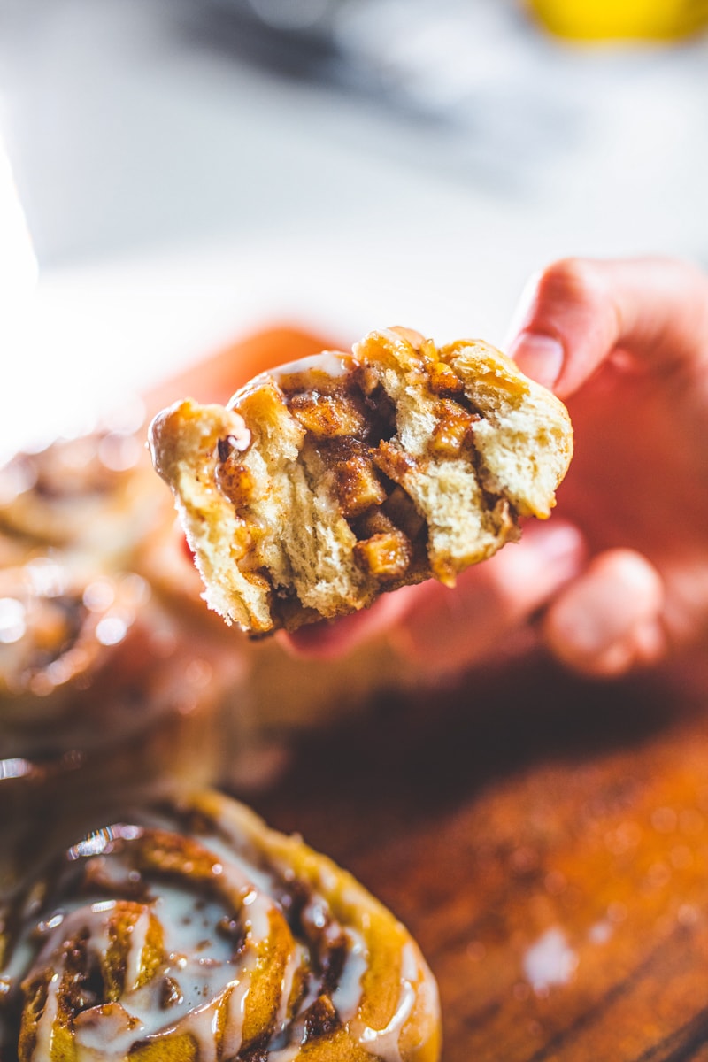 A bite from Apple Pie Cinnamon Rolls - Georgie Eats