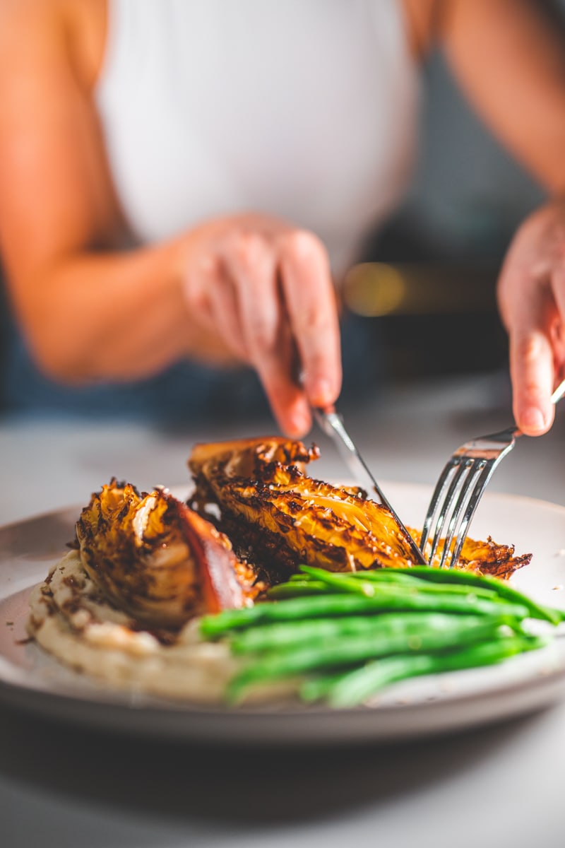 Cutting the Roasted Cabbage Steaks with Miso Mash - Georgie Eats