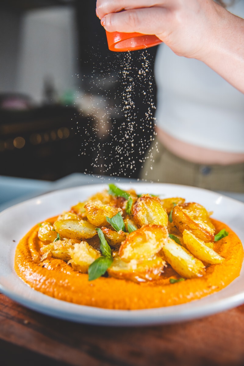Serving the Romesco & Crispy Parm Potatoes - Georgie Eats
