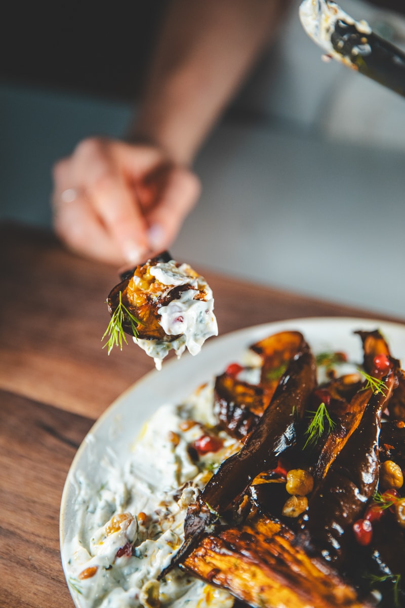 A bite of Harissa Aubergine Salad with Herby Yoghurt - Georgie Eats