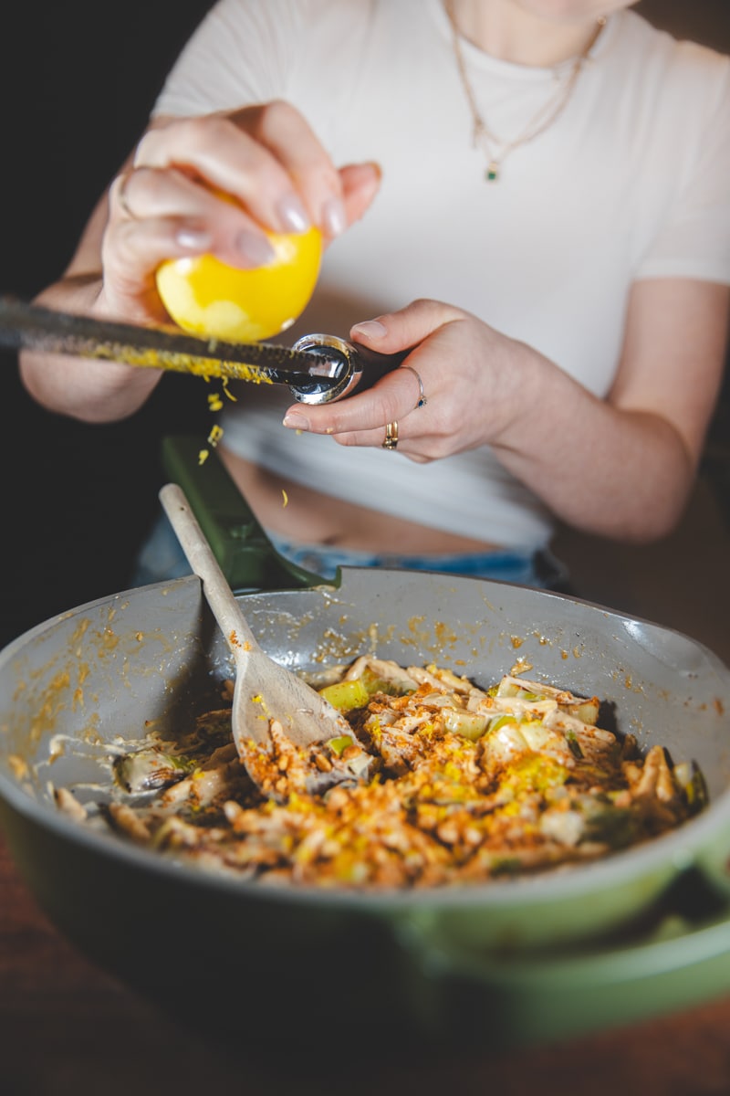 Grating lemon zest on Creamy Leek & Miso Pasta - Georgie Eats