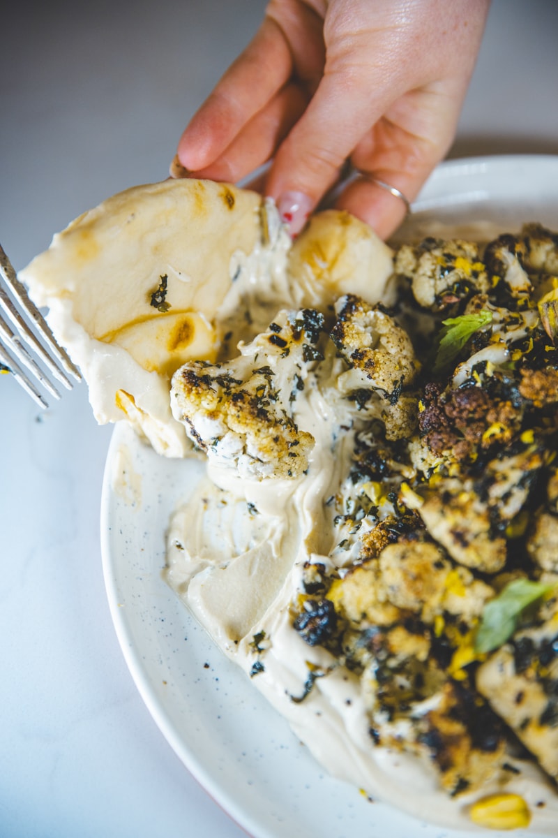 eating Marinated Cauliflower & Tofu Ricotta with flatbread - Georgie Eats