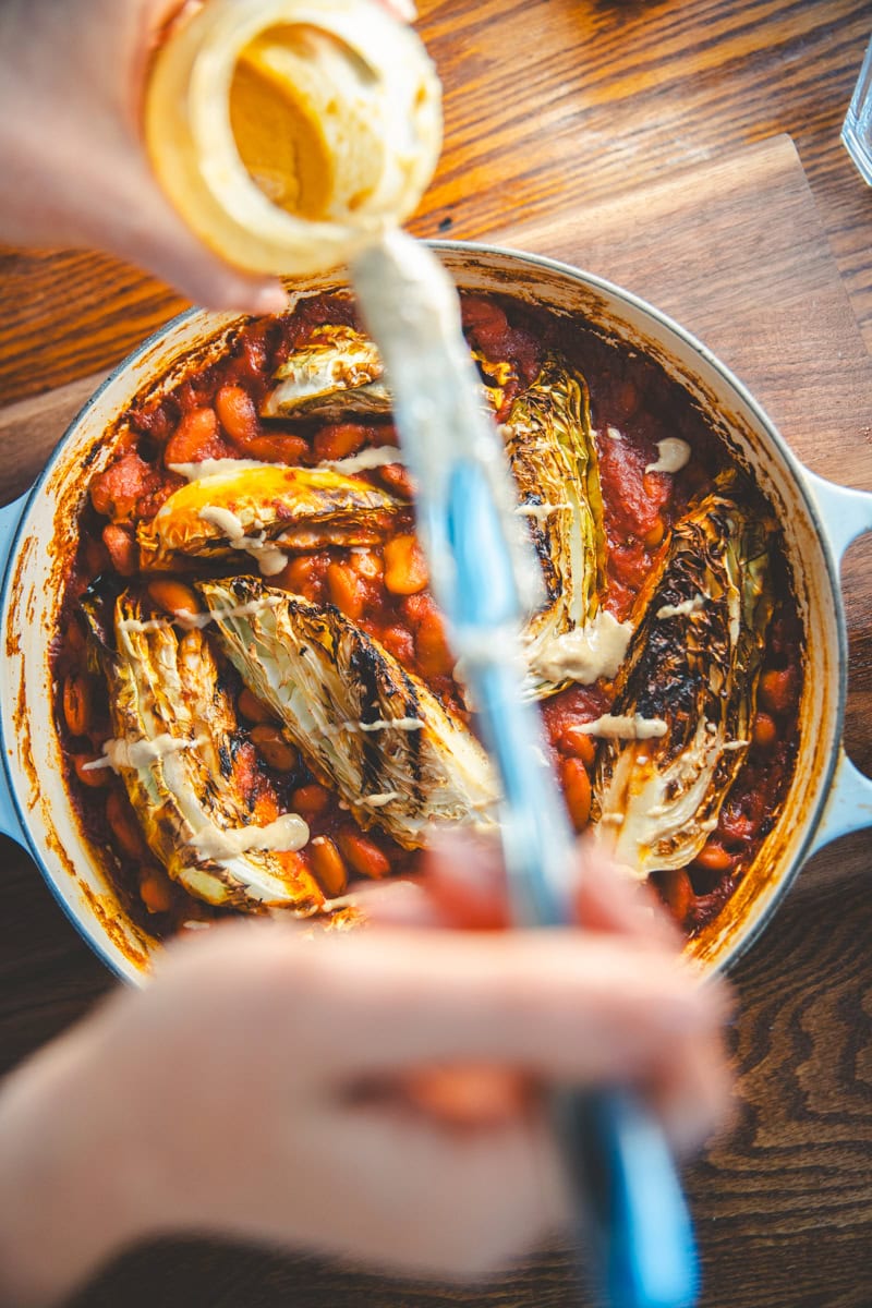 Tahini on Harissa Butter Bean & Hispi Cabbage Bake - Georgie Eats