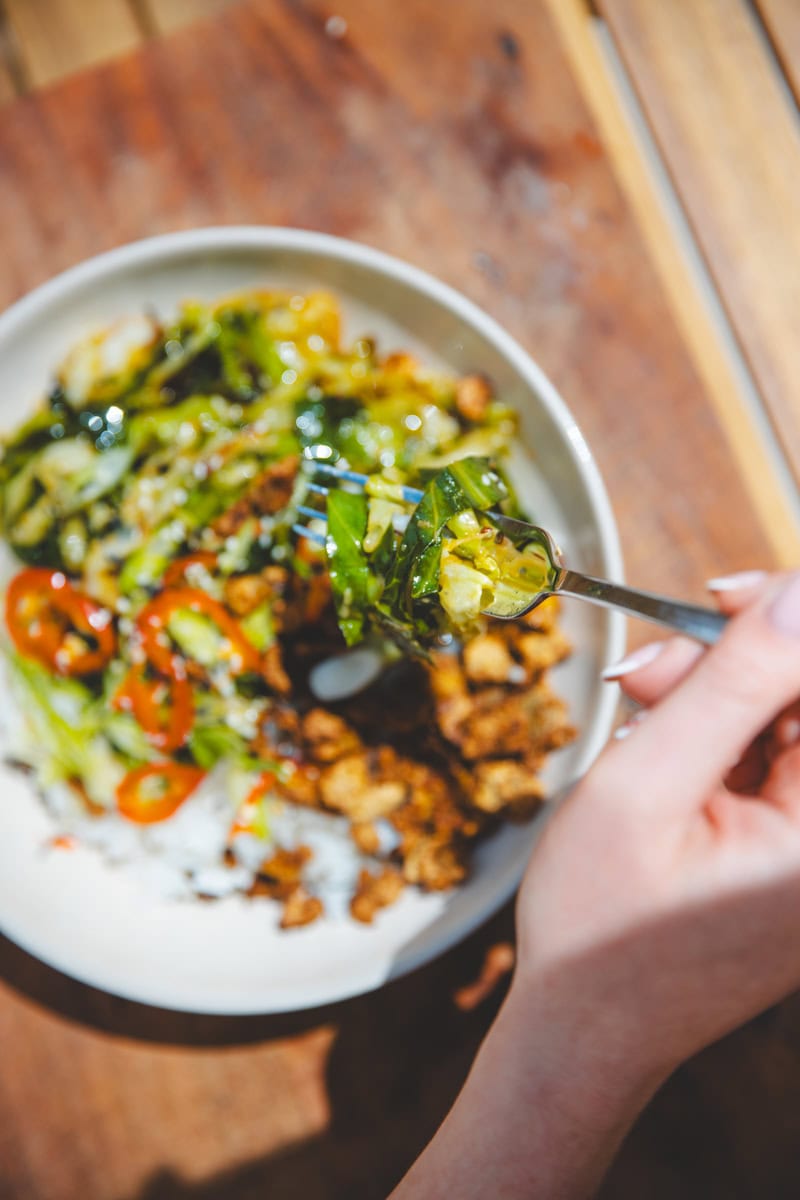 A forkful of Hispi Cabbage Stir-Fry & Crispy Tofu Bowls - Georgie Eats