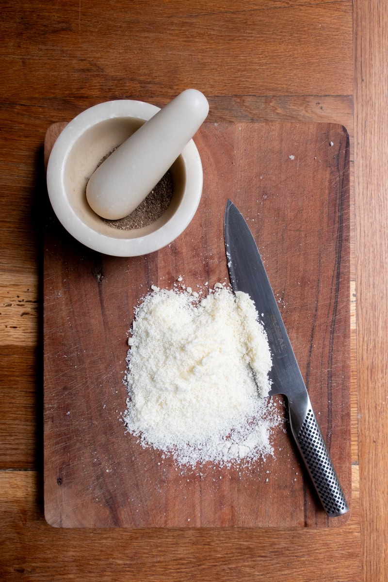 Grated pecorino on a chopping board - Georgie Mullen